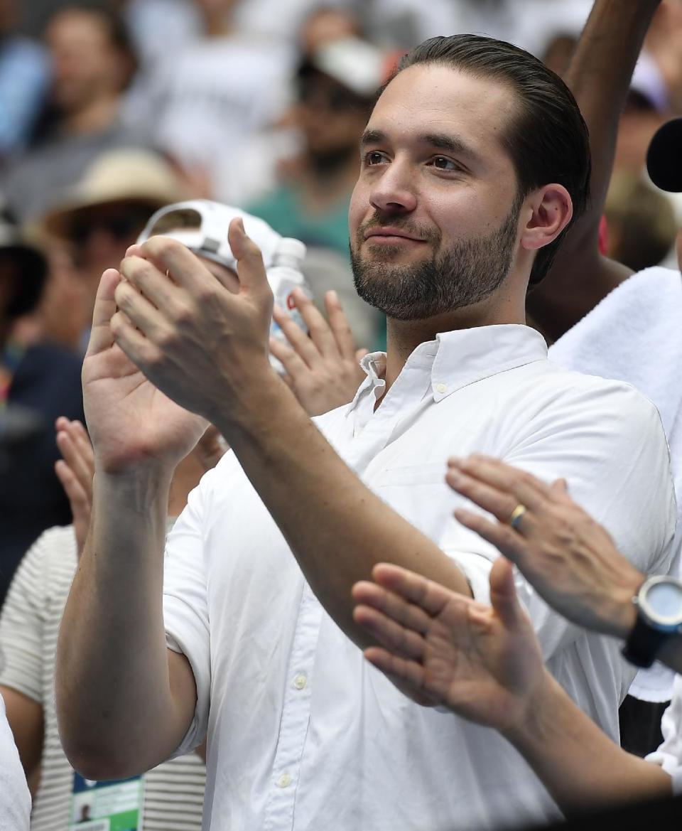 Reddit co-founder Alexis Ohanian applauds as he watches his fiancee United States' Serena Williams defeat Switzerland's Belinda Bencic in her first round match at the Australian Open tennis championships in Melbourne, Australia, Tuesday, Jan. 17, 2017. (AP Photo/Andy Brownbill)