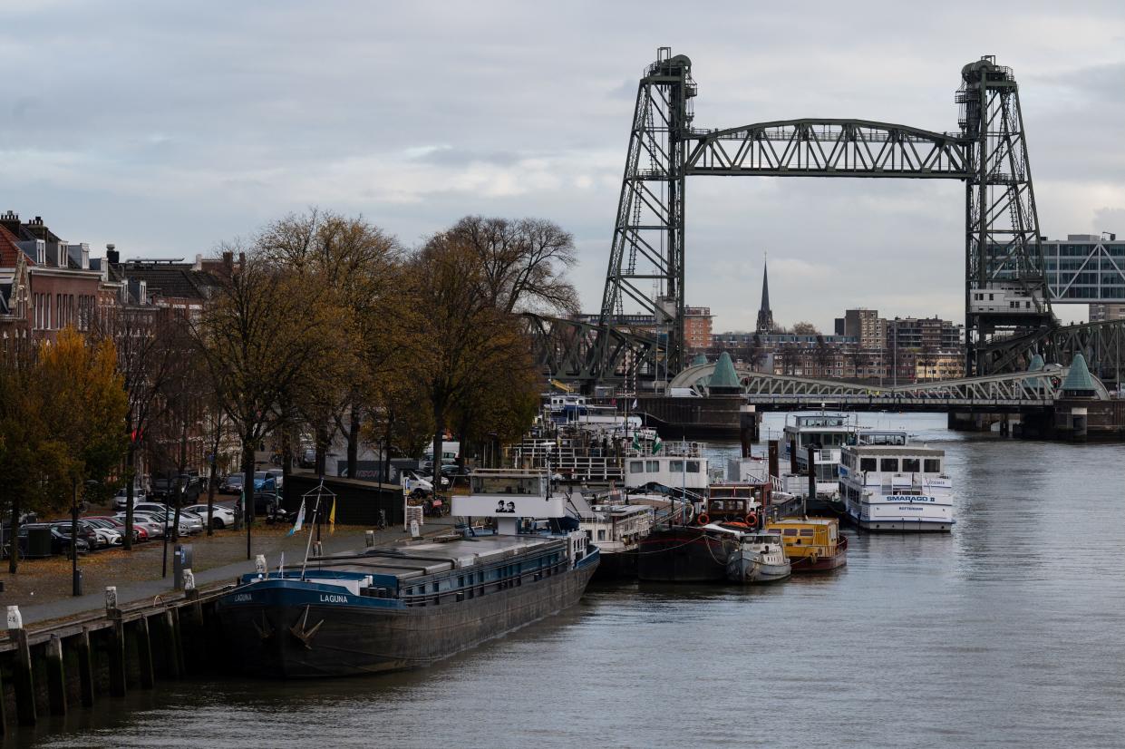 Barges docked on the waterway ahead of the Koningshavenbrug lift bridge and Koninginnebrug drawbridge (front) in Rotterdam. (AFP via Getty Images)