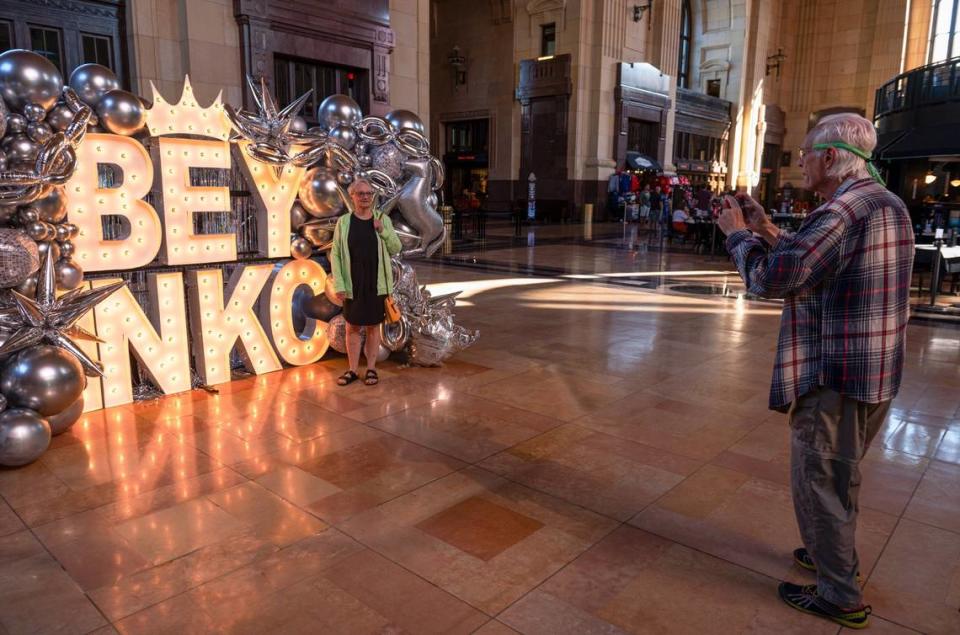 Kathy Warnock, left, stands in front of a Beyoncé themed sign while her husband Rodger Warnick takes a photo on Friday at Union Station. The couple are from Shiloh, Ill.