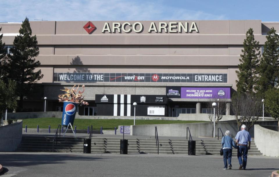 FILE - In this Jan. 12, 2011, file photo, people approach Arco Arena, home of the Sacramento Kings NBA basketball team, in Sacramento, Calif. The city of Sacramento, the NBA and the Kings have announced a tentative deal to finance a new arena that would keep the team in California's capital. Sacramento Mayor Kevin Johnson, NBA Commissioner David Stern and the Maloof family, which owns the Kings, announced Monday, Feb. 27, 2012, in Orlando, Fla., that an agreement had been reached. (AP Photo/Rich Pedroncelli, file)