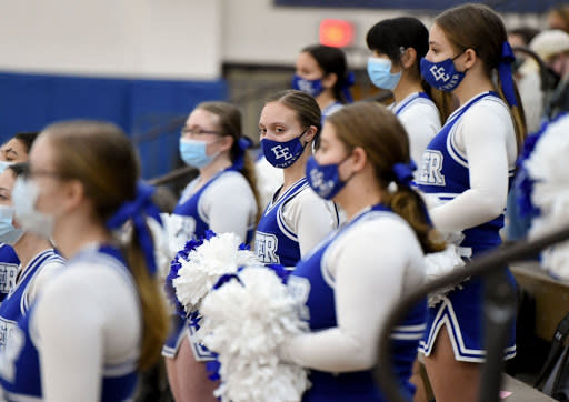 Dec. 11: Exeter High School cheerleaders in Reiffton, Pennsylvania, wearing masks at a basketball game. (Getty Images)