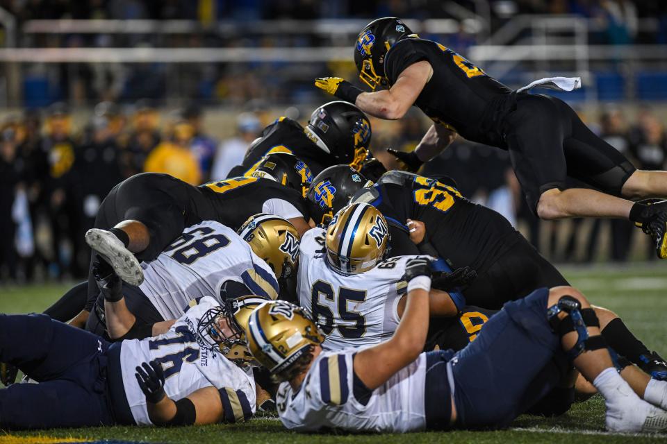 Football players from both South Dakota State and Montana State pile on each other at Dana J. Dykhouse Stadium in Brookings, South Dakota on Saturday, Sept. 9, 2023.