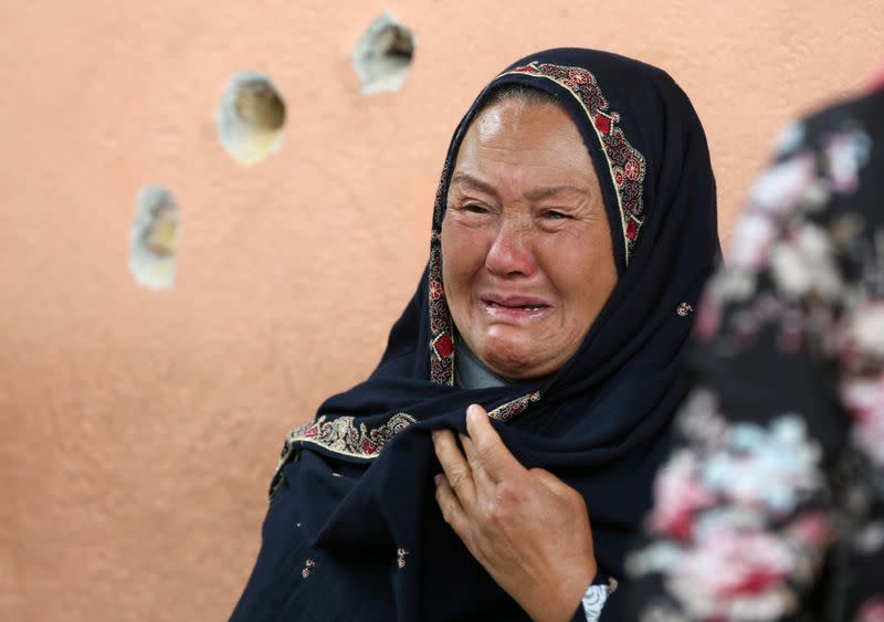 FILE PHOTO: An Afghan woman cries while looking for her relative at a hospital which came under attack yesterday in Kabul