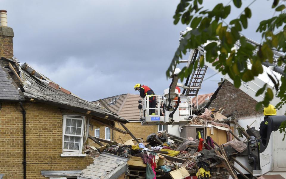 Emergency services work at the scene of a fallen tree at Bath Road in Hounslow, west London October 28, 2013. Britain's strongest storm in a decade battered southern regions on Monday, forcing hundreds of flight cancellations, cutting power lines and disrupting the travel plans of millions of commuters. Winds of up to 99 miles per hour (160 km per hour) lashed southern England and Wales in the early hours of Monday, shutting down rail services in some areas during rush hour. (REUTERS/Toby Melville)