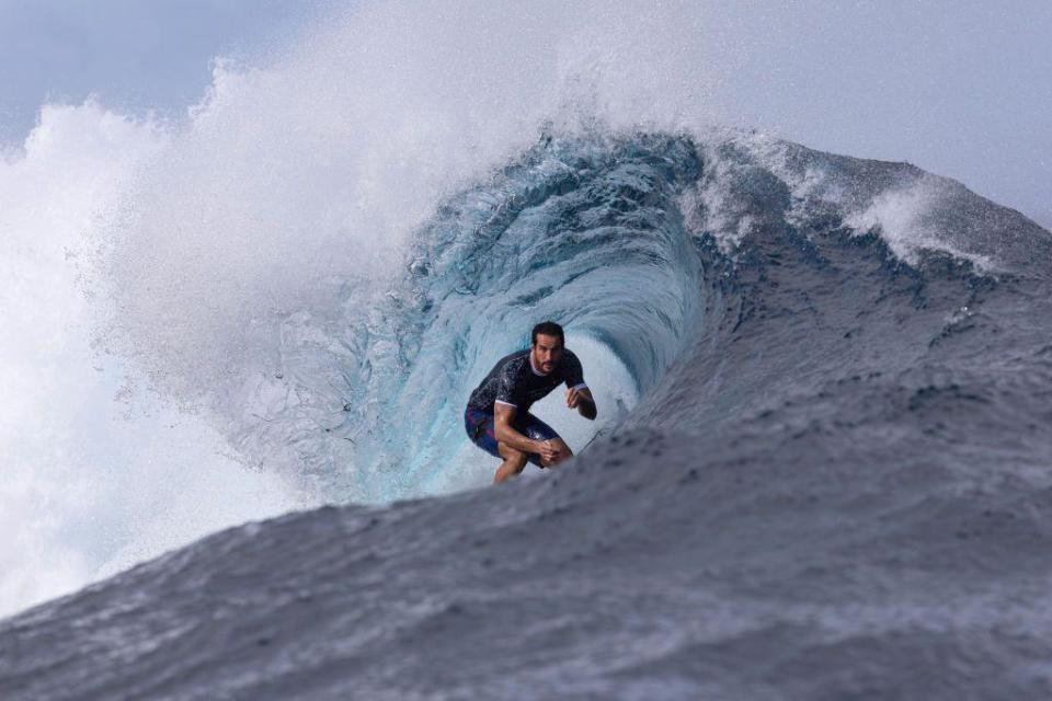 Moroccan Ramzi Boukhiam surfs inside the barrel of a wave. The water appears to curl around him in Tahiti - Wednesday 24 July 2024 