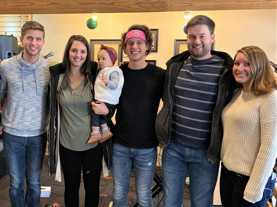 Caleb Liechty (from left), Elise Bontrager and baby Clara, Joshua Liechty, Aaron Bontrager and Bekah Liechty of the winning trio on "The Voice," Girl Named Tom, on a visit with the Bontragers to a coffee shop in Bryan near their hometown in 2019.