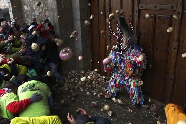 During the annual Jarramplas festival in Piornal, Spain, on January 20, 2016, hundreds of people ran through the streets, chasing a costumed person and pelting him with turnips. See more photos of the festival <a href="http://www.theatlantic.com/photo/2016/01/the-2016-jarramplas-festival/425115/?utm_source=yahoo" rel="nofollow noopener" target="_blank" data-ylk="slk:here;elm:context_link;itc:0;sec:content-canvas" class="link ">here</a>. (Francisco Seco / AP)