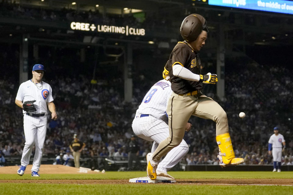 San Diego Padres' Ha-Seong Kim reach first on an infield hit as Chicago Cubs first baseman Frank Schwindel fields the late throw from Jonathan Villar during the fifth inning of a baseball game Monday, June 13, 2022, in Chicago. (AP Photo/Charles Rex Arbogast)