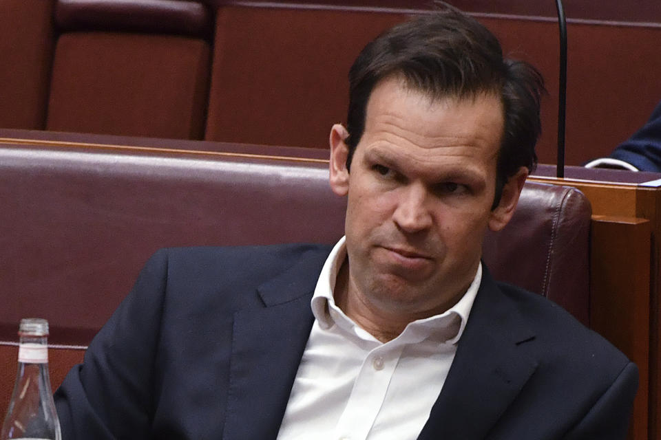 Nationals party Senator Matt Canavan sits in the chamber at Parliament House in Canberra, Tuesday, Oct. 19, 2021. A net zero carbon emissions target by 2050 would be a "great positive" for Australia if it can be achieved through technology and not a carbon price, the prime minister said as he pressures government colleagues to commit to more ambitious climate change action ahead of the Glasgow summit. Canavan was among the lawmakers who did not believe the modeling. (Mick Tsikas/AAP Image via AP)