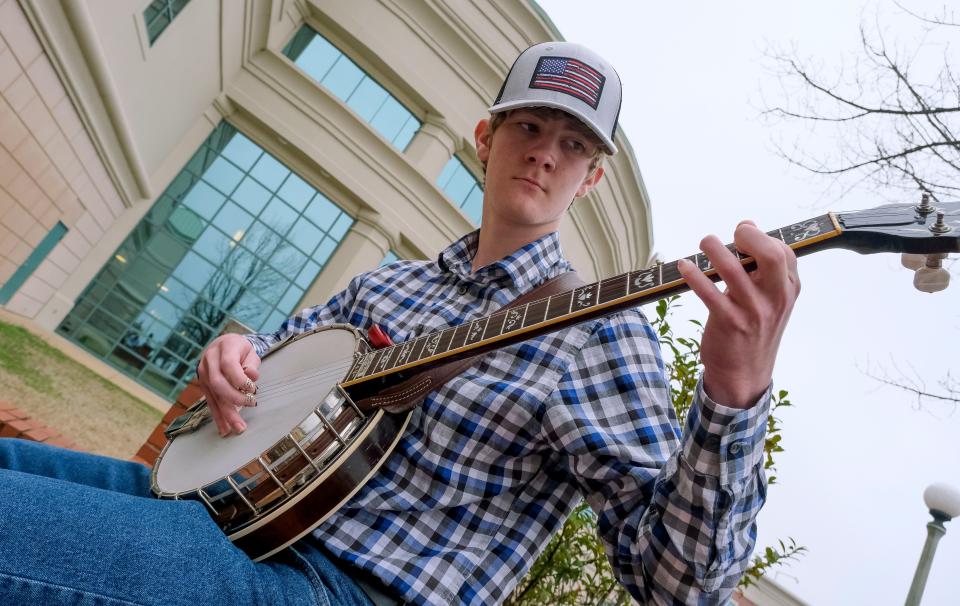 Feb 25, 2023; Tuscaloosa, AL, USA; Conner McMeans jams with his banjo outside the concert hall during Fiddle Fest 2023 at Shelton State Saturday.