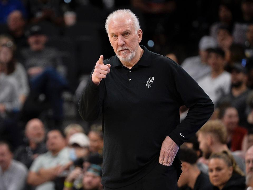 Gregg Popovich stands on the sideline and points during a game in 2022.