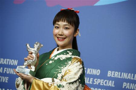 Actress Haru Kuroki poses with her Silver Bear for Best Actress in the film 'Chiisai Ouchi' (The Little House) during a news conference after the awards ceremony of the 64th Berlinale International Film Festival in Berlin February 15, 2014. REUTERS/Thomas Peter