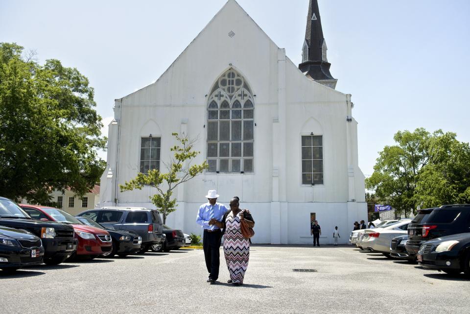 People depart the Emanuel AME Church following Sunday services June 21, 2015 in Charleston, South Carolina.  Large crowds are expected at Sunday's service at the black church in Charleston where nine African Americans were gunned down, as a chilling website apparently created by the suspected white supremacist shooter emerged. The service will be the first since the bloodbath on Wednesday at the Emanuel African Methodist Episcopal Church in the southern state of South Carolina, which has fuelled simmering racial tensions in the United States and reignited impassioned calls for stronger gun-control laws. AFP PHOTO/BRENDAN SMIALOWSKI        (Photo credit should read BRENDAN SMIALOWSKI/AFP/Getty Images)