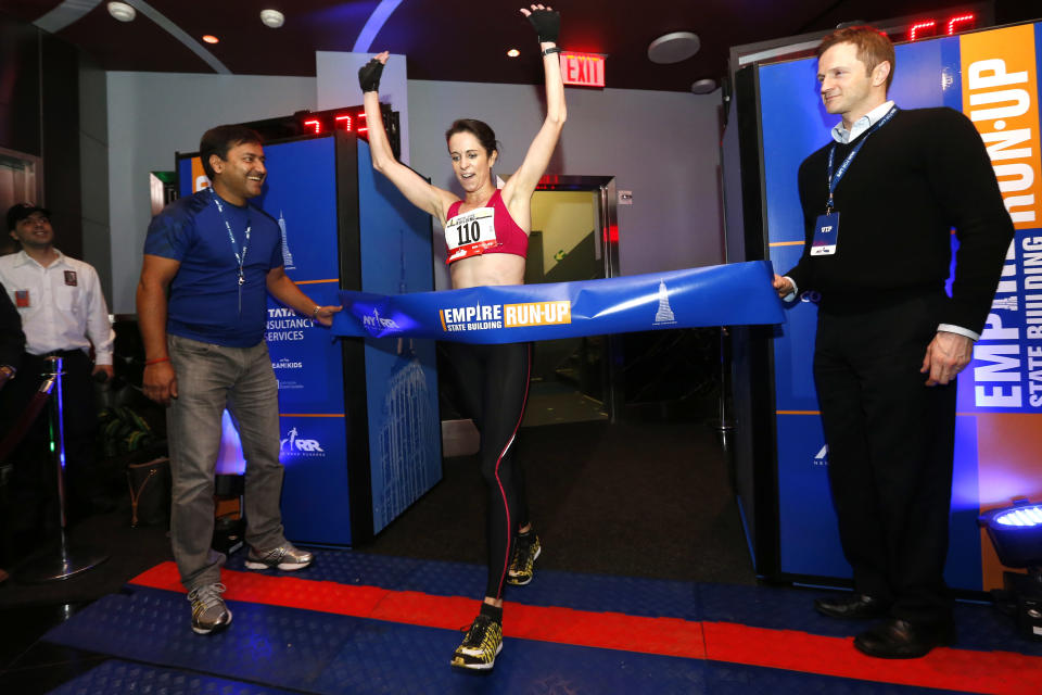 Australia's Suzy Walsham celebrates as she wins the women's division of the Empire State Building Run-Up, Wednesday, Feb. 5, 2014, in New York. Walsham, who was also last year's champion, has now won the race a record five times. (AP Photo/Jason DeCrow)