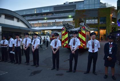 G4S security guards stand near fire engines outside Centre Court following a fire alert and evacuation on day three of the 2015 Wimbledon Championships at The All England Tennis Club in Wimbledon, southwest London, on July 1, 2015 (AFP Photo/Leon Neal)