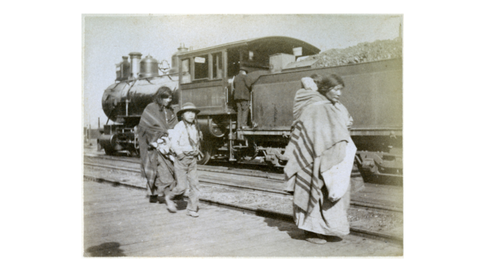 Native Americans signed away rights to most of their land through treaties with the Federal Government, but the railroad drastically altered the landscape making it impossible to hunt. This Native American family walks by one of these trains in the 1890s. (Photo: University of Montana Maureen and Mike Mansfield Library)