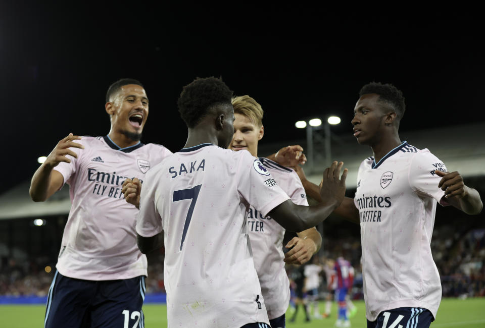 Arsenal players celebrate after Crystal Palace's Marc Guehi scores an own goal past his goalkeeper during the English Premier League soccer match between Crystal Palace and Arsenal at Selhurst Park stadium in London, Friday, Aug.  5, 2022. (AP Photo/Ian Walton)