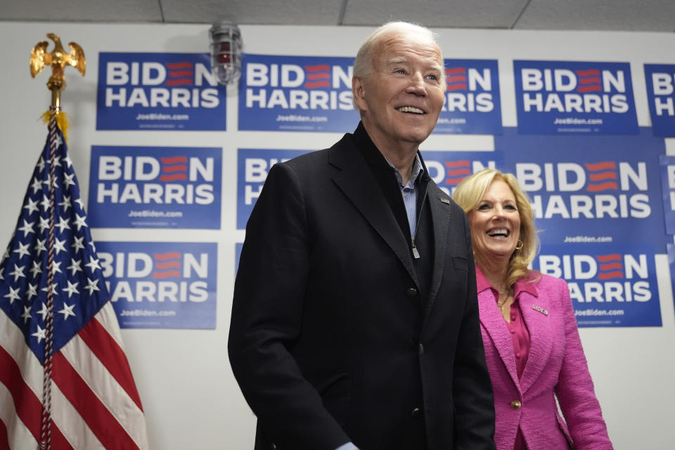 President Joe Biden, left, waits to speak as first lady Jill Biden looks on at the Biden campaign headquarters in Wilmington, Del., Saturday, Feb. 3, 2024. (AP Photo/Alex Brandon)