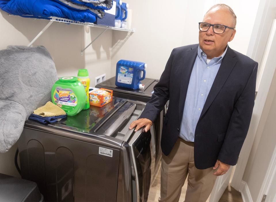 Paul Herrera, CEO of Hope Homes Foundation Inc., talks about the "smart" washer and dryer for residents with developmental disabilities living at Stark County's first "Smart Home" in Plain Township.