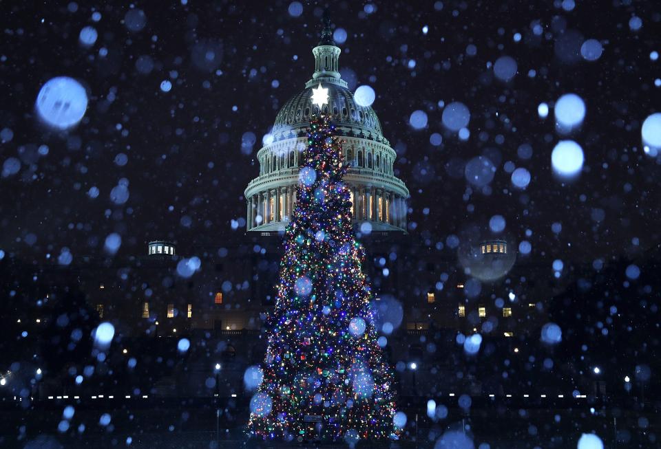 A wintry mix of sleet and snow falls on the U.S. Capitol and its Christmas tree on Dec. 16, 2019, in Washington, D.C.