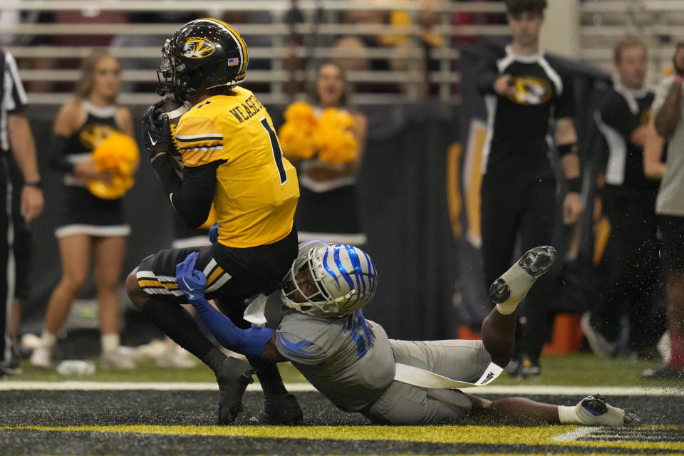 Missouri wide receiver Theo Wease Jr. (1) catches a touchdown pass as Memphis defensive back DeAgo Brumfield defends during the second half of an NCAA college football game Saturday, Sept. 23, 2023, in St. Louis. (AP Photo/Jeff Roberson)