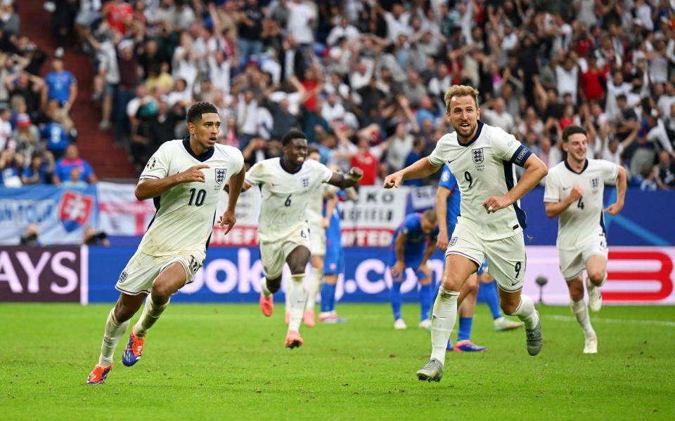 Jude Bellingham of England celebrates scoring his team's first goal with team-mate Harry Kane