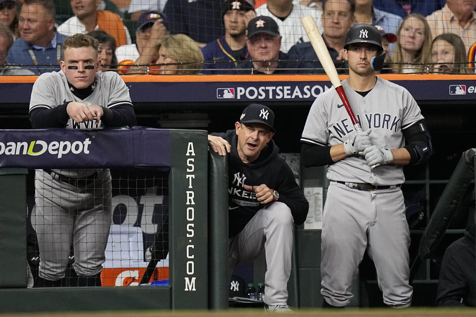 New York Yankees manager Aaron Boone, center, watches play during the second inning in Game 2 of baseball's American League Championship Series between the Houston Astros and the New York Yankees, Thursday, Oct. 20, 2022, in Houston. (AP Photo/Eric Gay)