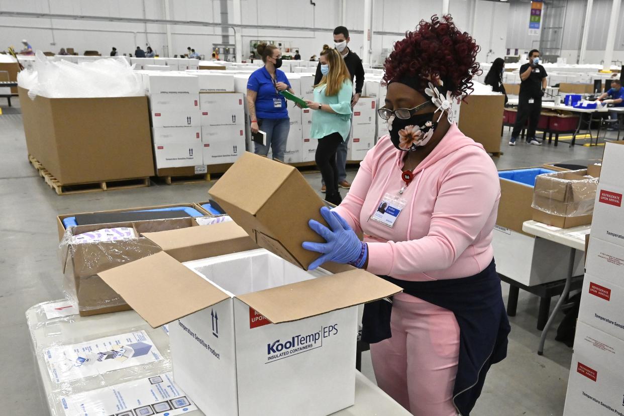 An employee with the McKesson Corporation packs a box of the Johnson and Johnson COVID-19 vaccine into a cooler for shipping from their facility in Shepherdsville, Ky. on Monday, March 1, 2021.