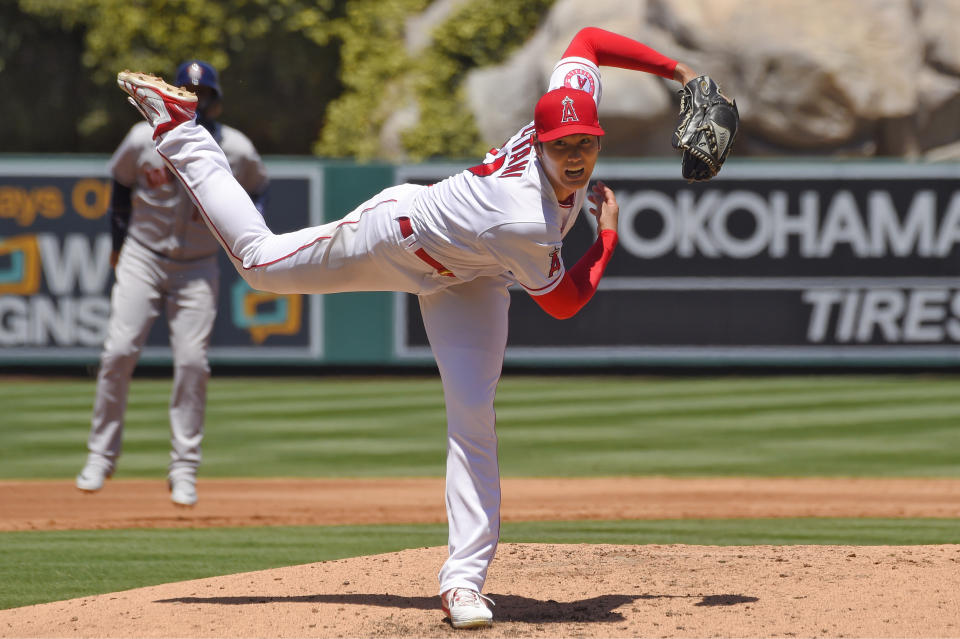 Los Angeles Angels pitcher Shohei Ohtani, right, of Japan, follows through as Houston Astros' Yuli Gurriel leads off during the second inning of a baseball game Sunday, Aug. 2, 2020, in Anaheim, Calif. (AP Photo/Mark J. Terrill)
