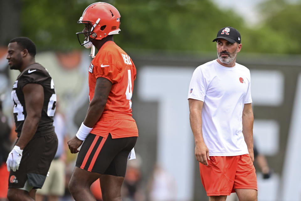 Cleveland Browns head coach Kevin Stefanski, right, walks near quarterback Deshaun Watson during an NFL football practice in Berea, Ohio, Sunday, Aug. 7, 2022. (AP Photo/David Dermer)