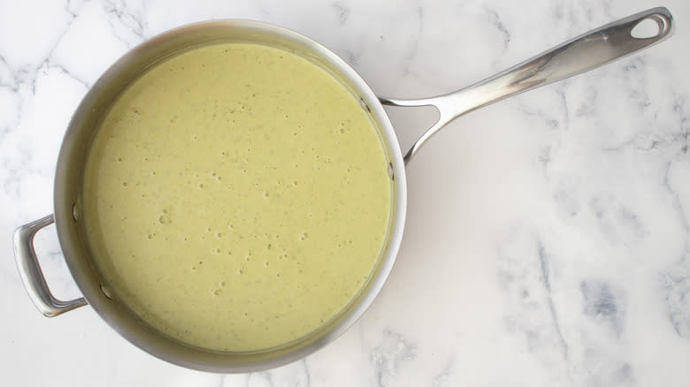 whisked sauce simmering in saucepan