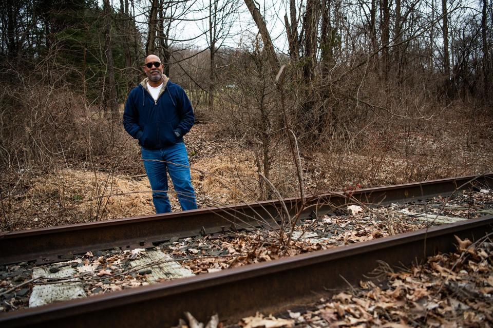 Ian Mandrew Prendergast of Poughquag stands for a portrait on a portion of a rail trail that borders his property in Poughquag, NY on Saturday, March 9, 2024.