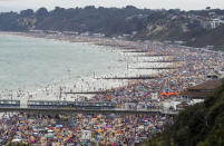 People enjoy the warm weather on Bournemouth beach. Met Office said Friday is the third hottest UK day on record as temperatures reached 37.8C at Heathrow Airport.