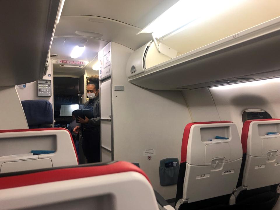 A Breeze Airways flight attendant prepares for an early morning flight from New Orleans.