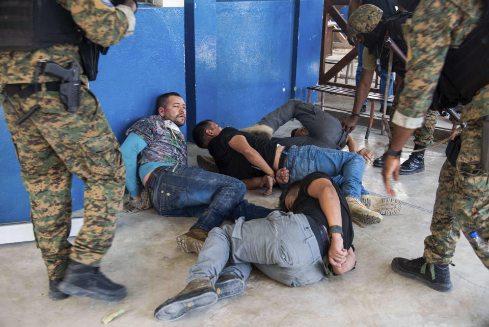 Suspects in the assassination of Haiti's President Jovenel Moise are tossed on the floor after being detained, at the General Direction of the police in Port-au-Prince, Haiti, Thursday, July 8, 2021. A Haitian judge involved in the murder investigation said that President Moise was shot a dozen times and his office and bedroom were ransacked.( AP Photo/Jean Marc Hervé Abélard)