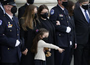 The family, including daughter Abigail, watch as the flag-draped casket of U.S. Capitol Police officer William "Billy" Evans, arrives to lie in honor at the U.S. Capitol, Tuesday, April 13, 2021 in Washington. (Carlos Barria/Pool via AP)