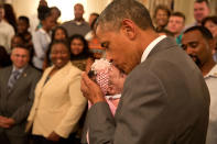 <p>“The President kisses a baby girl as he and the Vice President greeted wounded warriors and their families during their tour in the East Room of the White House on june 23, 2014.” (Pete Souza/The White House) </p>