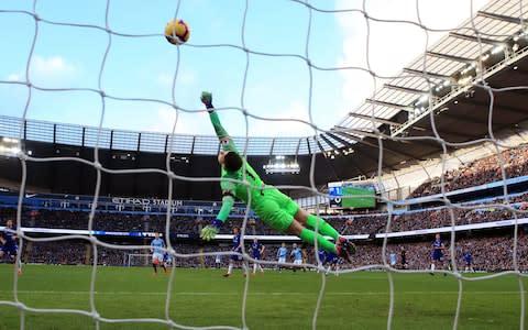 Chelsea goalkeeper Kepa Arrizabalaga dives in vain as Manchester City's Sergio Aguero (centre, background) scores his side's second goal of the game during the Premier League match at the Etihad Stadium, Manchester. PRESS ASSOCIATION Photo. Picture date: Sunday February 10, 2019. See PA story SOCCER Man City. Photo credit should read: Nick Potts/PA Wire. RESTRICTIONS: EDITORIAL USE ONLY No use with unauthorised audio, video, data, fixture lists, club/league logos or "live" services. Online in-match use limited to 120 images, no video emulation. No use in betting, games or single club/league/player publications - Credit: PA