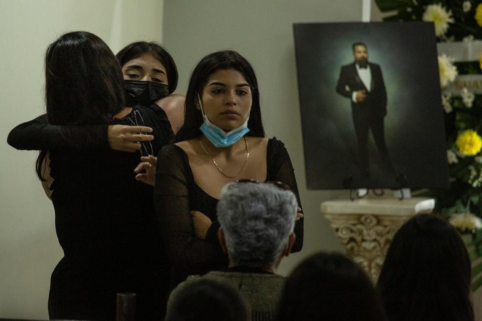 Relatives and friends mourn radio broadcaster Allán González during his funeral in Ciudad Juárez. González was among four radio state employees killed at a pizza shop in the city on Aug. 11, 2022.