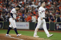 Houston Astros' Jose Altuve, left, and Alex Bregman walk to the dugout after a double play ends the seventh inning in Game 1 of baseball's American League Championship Series against the New York Yankees Saturday, Oct. 12, 2019, in Houston. (AP Photo/Eric Gay)