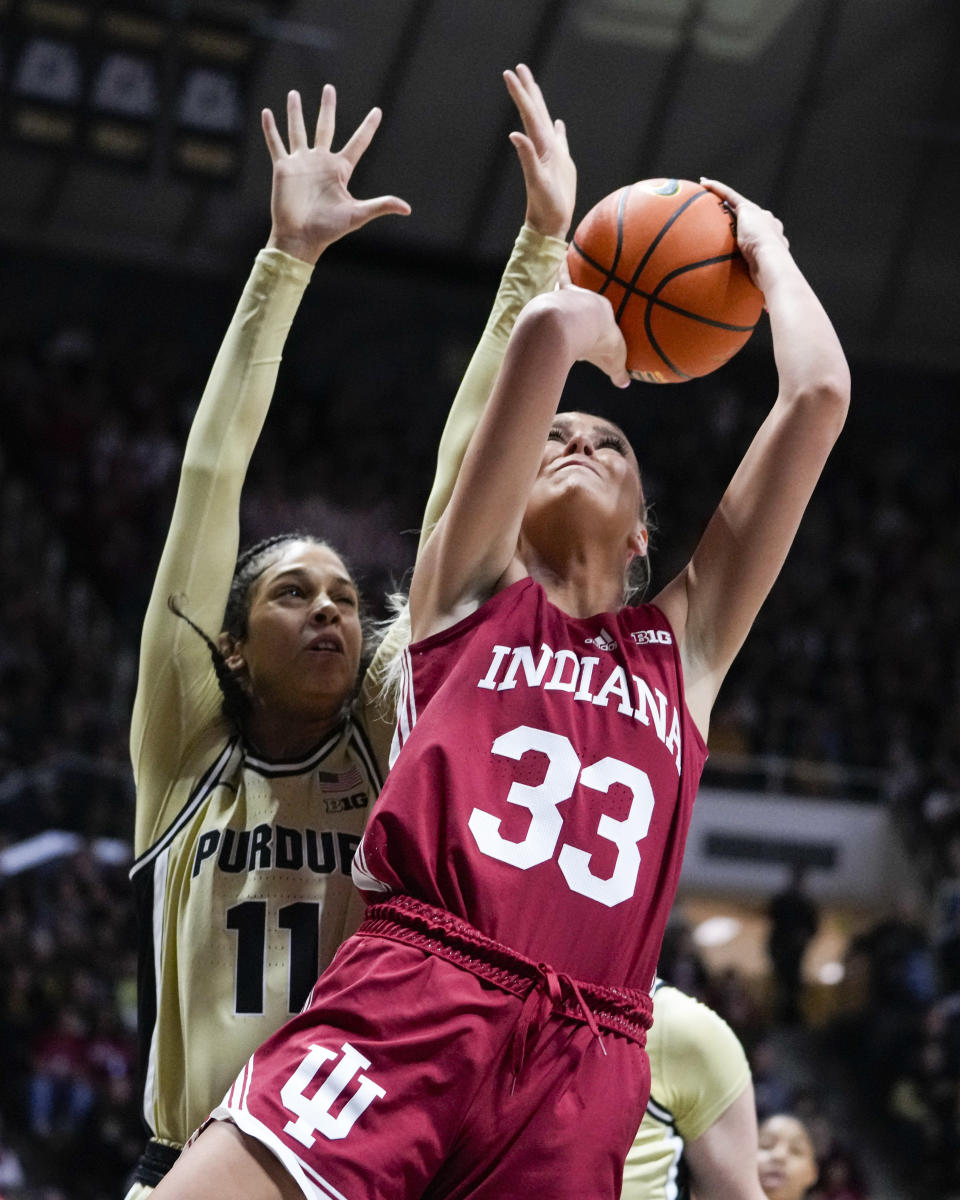 Indiana guard Sydney Parrish (33) shoots in front of Purdue guard Lasha Petree (11) the first half of an NCAA college basketball game in West Lafayette, Ind., Sunday, Feb. 5, 2023. (AP Photo/Michael Conroy)