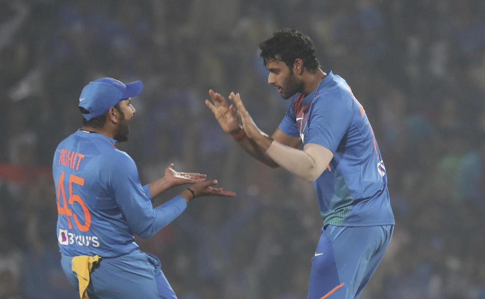 Indian players Shivam Dube, right, with Rohit Sharma celebrate the wicket of Bangladesh's Mushfiqur Rahim during their third Twenty20 international cricket match against India in Nagpur, India, Sunday, Nov. 10, 2019.(AP Photo/Rafiq Maqbool)