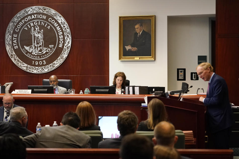 Joseph Reid, of McGuireWoods, representing Dominion, right, speaks as commissioners, Jehmal Hudson, left, and Judith Williams Jagdmann, listen during a meeting of the State Corporations Commission Tuesday May 17, 2022, in Richmond, Va. The commission was reviewing an application for Dominion's offshore wind project. (AP Photo/Steve Helber)