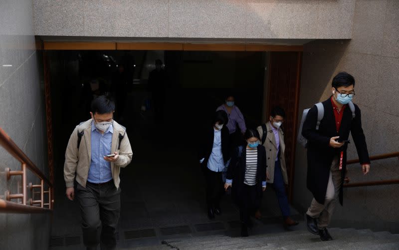 People wearing face masks exit a subway station following an outbreak of the coronavirus disease (COVID-19), in Beijing