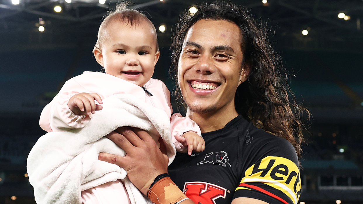 Jarome Luai (pictured holding his daughter) also welcomed the birth of his third child this week, ahead of the NRL grand final. (Getty Images)