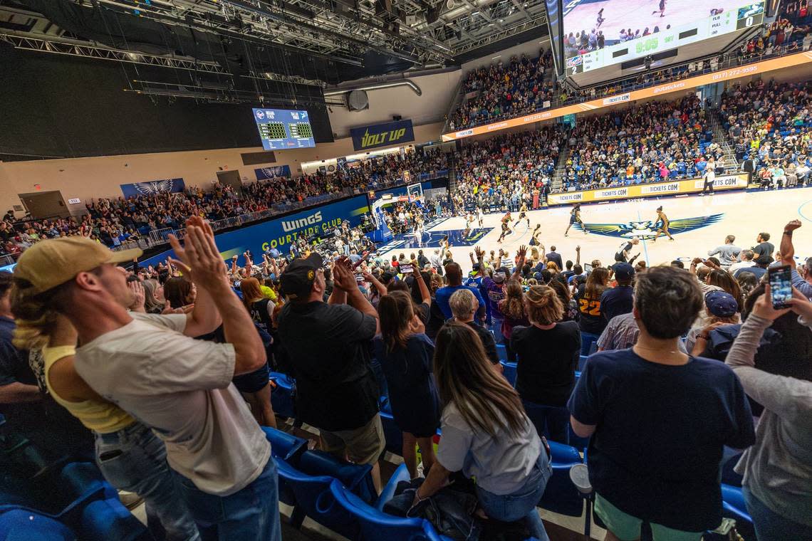 WNBA fans cheer after Indiana Fever guard Caitlin Clark (22) makes her first basket as a WNBA player in the first quarter of a WNBA preseason game against the Dallas Wings at College Park Center in Arlington on Friday, May 3, 2024.