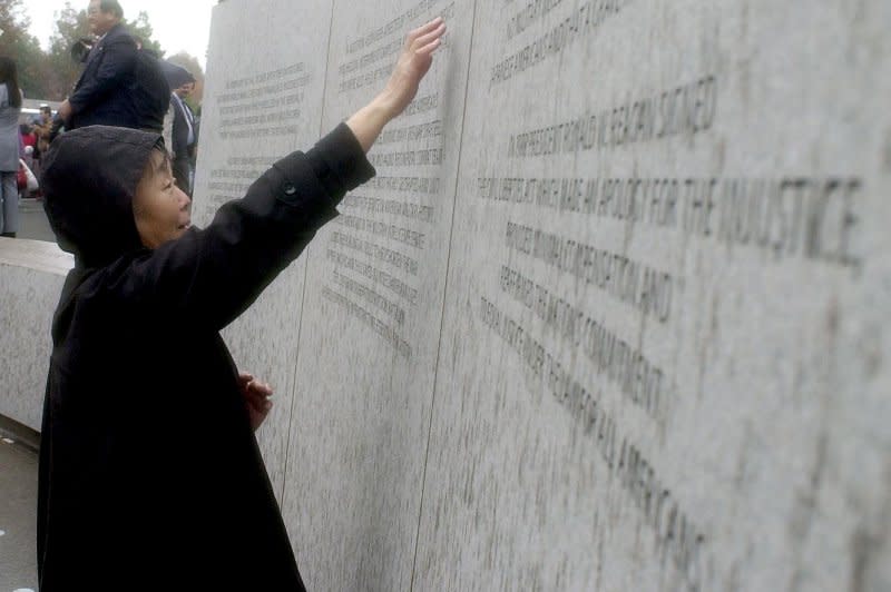 A Japanese-American woman visits the National Japanese American Memorial during the dedication November 9, 2000, in Washington, D.C. The memorial is dedicated to the 120,000 Japanese Americans who were interned in camps and the 800 who died fighting during World War II. President Roosevelt signed an executive order starting the relocations on February 19, 1942. File Photo by Roger L. Wollenberg/UPI