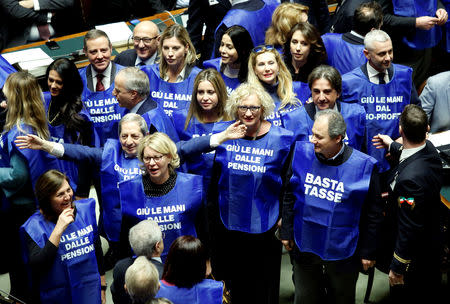 Members of Forza Italia party demonstrate during a final vote on Italy's 2019 budget law at the Lower House of the Parliament in Rome, Italy, December 29, 2018. Shirts read: "Hands off from pensions", "Stop taxes". REUTERS/Remo Casilli