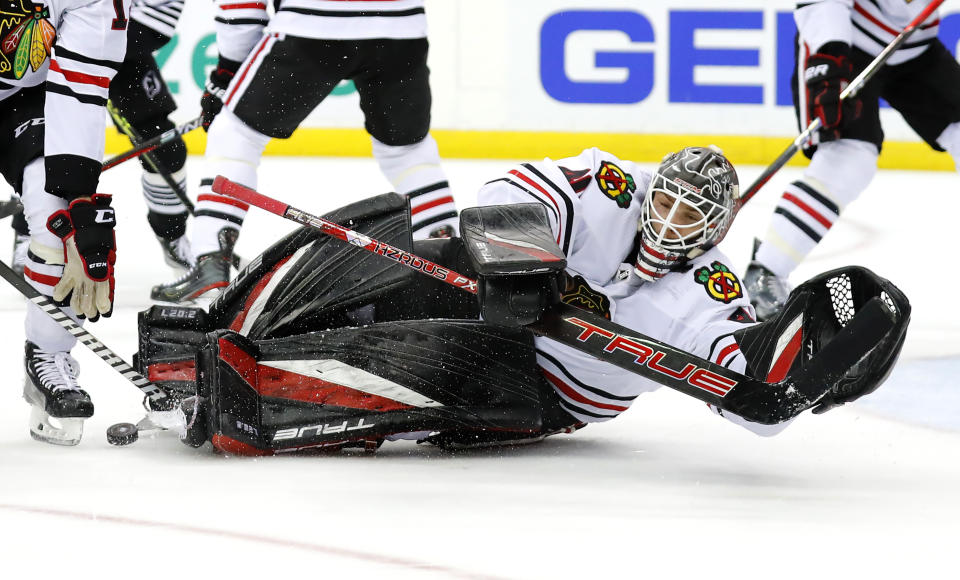 Chicago Blackhawks goaltender Arvid Soderblom sprawls to stop a shot by the New Jersey Devils during the first period of an NHL hockey game Tuesday, Dec. 6, 2022, in Newark, N.J. (AP Photo/Noah K. Murray)