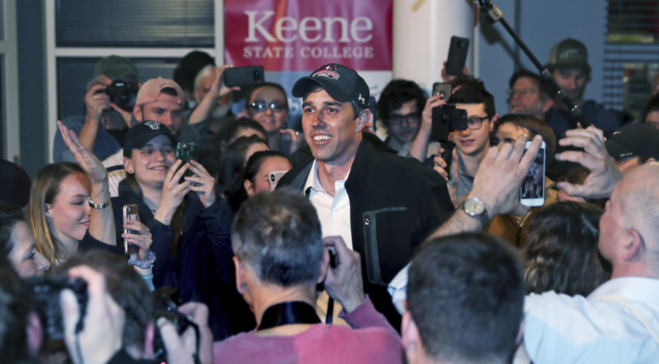 Former Texas congressman Beto O'Rourke smiles as he is surrounded while arriving for a campaign stop at Keene State College in Keene, N.H., Tuesday, March 19, 2019. O'Rourke announced last week that he'll seek the 2020 Democratic presidential nomination. (AP Photo/Charles Krupa)